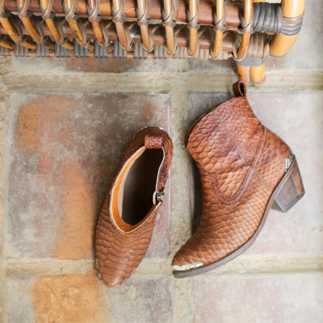 Ankle boots by Seminyak Leather Bali made of snakeskin leather in antique brown color. Loose fit cut with carved metal detailing on the toe cap and heel. 5 cm wooden Cuban-style heel. Zipper closure. Edgy and chic footwear for bold fashion statements.