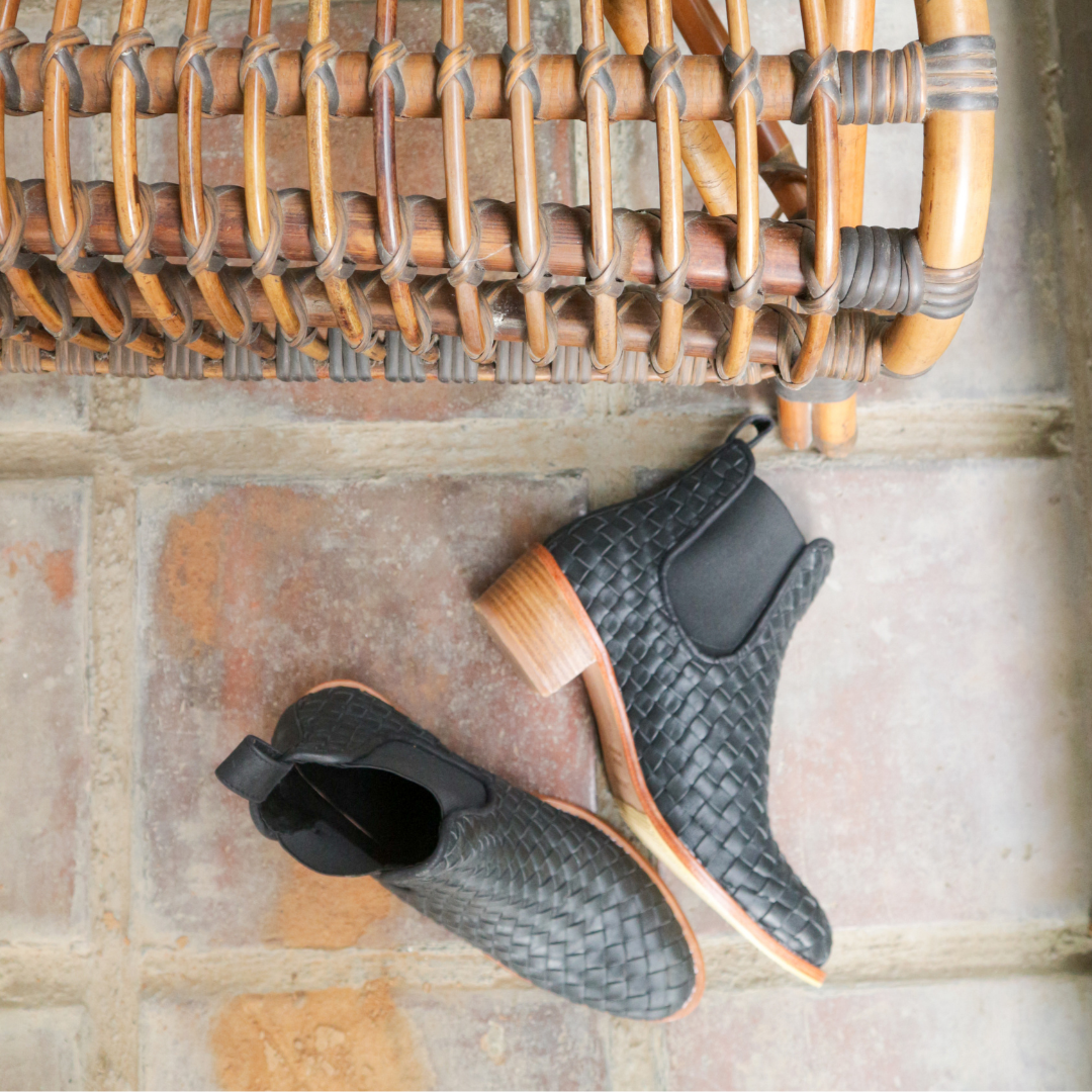Ankle boots with leather woven detailing in a slim fit cut by Semminyak Leather Bali. Elastic closure with carved metal accents on toe cap and heel. 5 cm wooden heel with a rounded toe design. Stylish and sophisticated footwear with a natural finish, perfect for making a fashion statement.