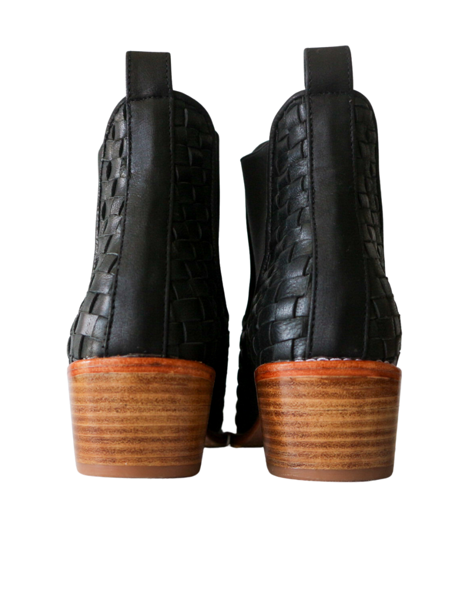 Ankle boots with leather woven detailing in a slim fit cut by Semminyak Leather Bali. Elastic closure with carved metal accents on toe cap and heel. 5 cm wooden heel with a rounded toe design. Stylish and sophisticated footwear with a natural finish, perfect for making a fashion statement.