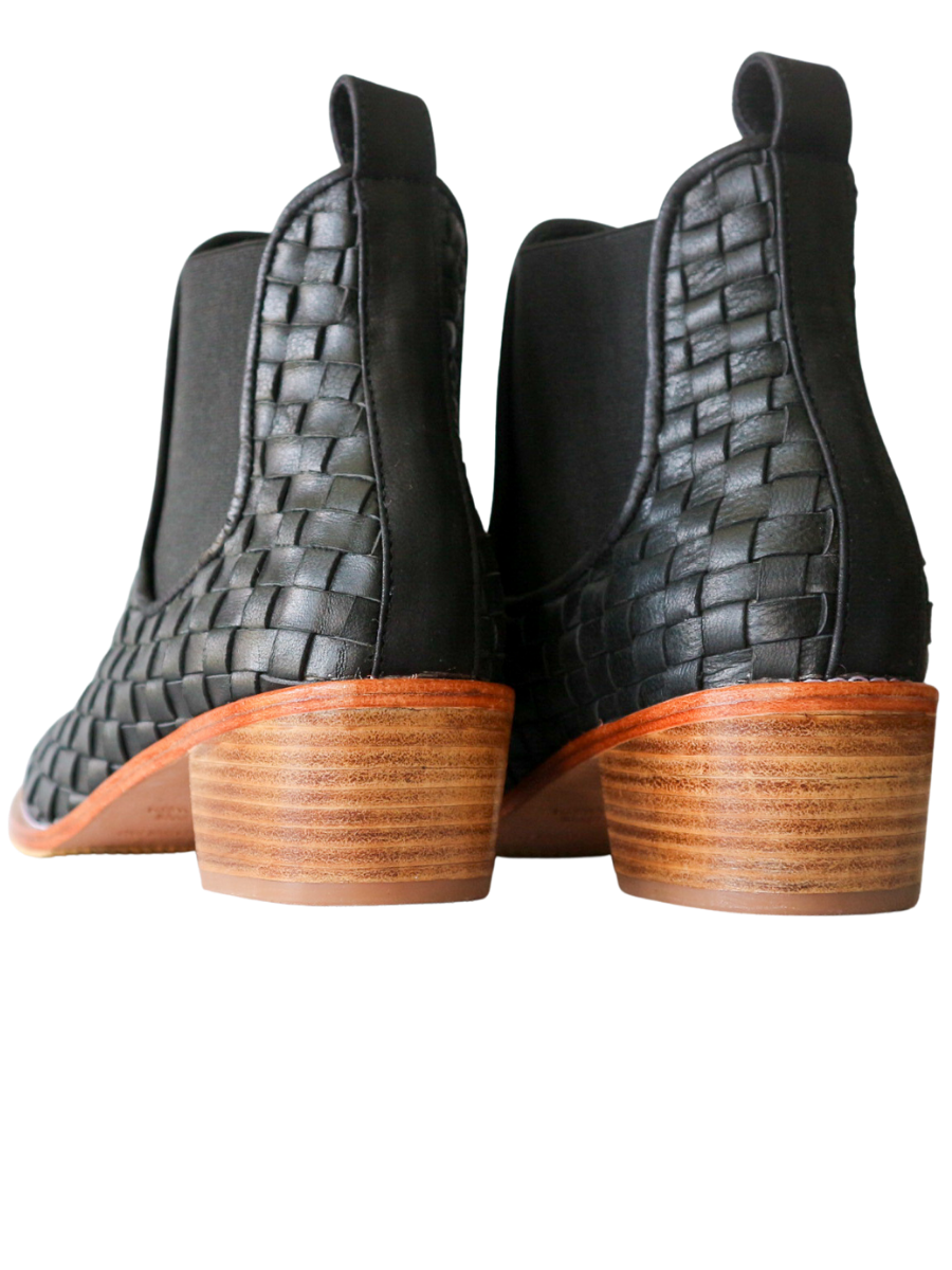 Ankle boots with leather woven detailing in a slim fit cut by Semminyak Leather Bali. Elastic closure with carved metal accents on toe cap and heel. 5 cm wooden heel with a rounded toe design. Stylish and sophisticated footwear with a natural finish, perfect for making a fashion statement.