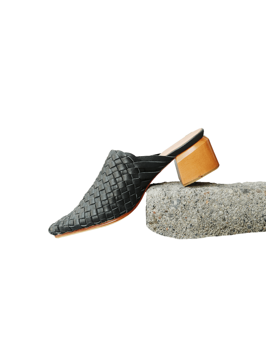 Black pointy woven heels with diagonal cut heels. Woven leather upper for a custom fit. 5 cm height. A blend of modern elegance and artisanal craftsmanship.