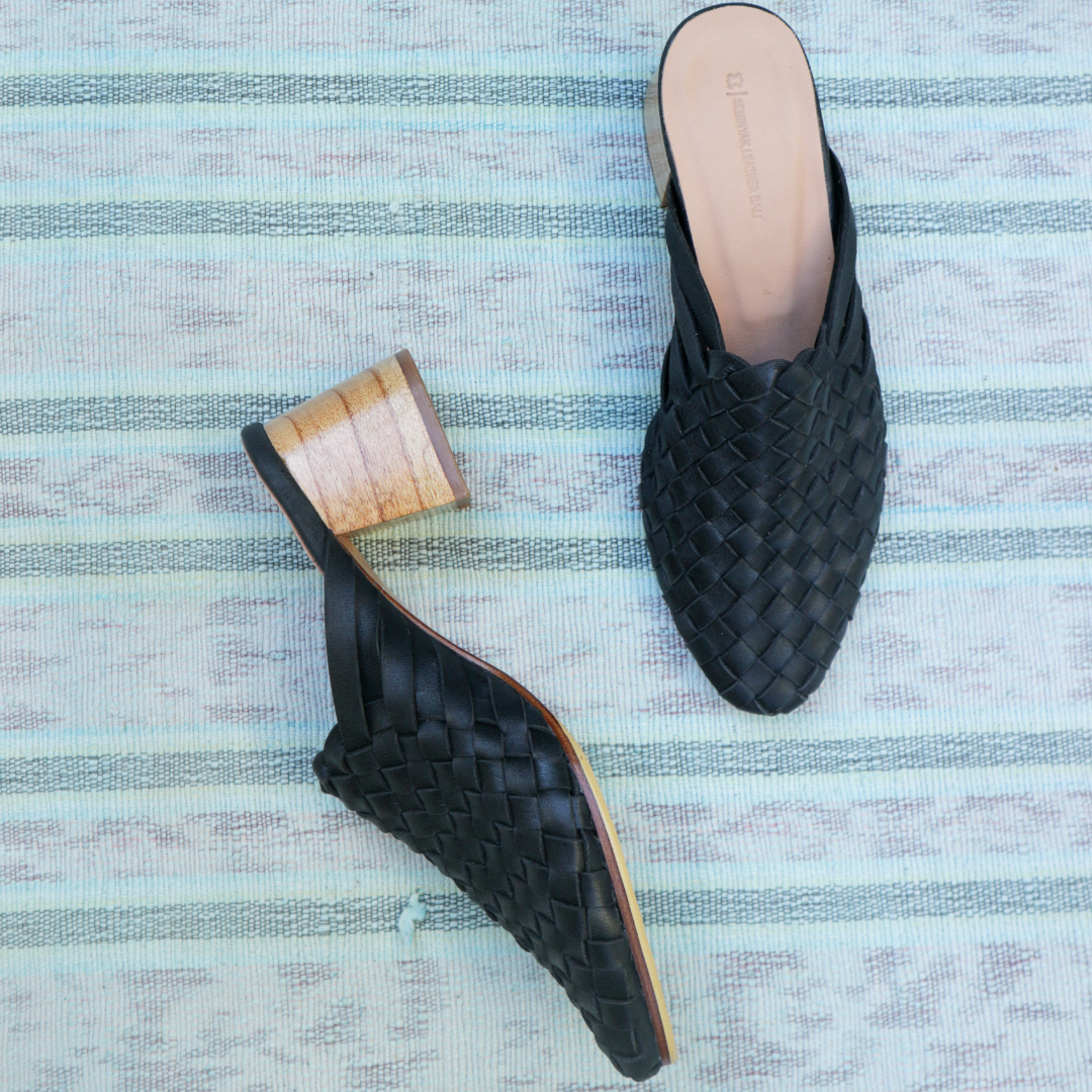 Black heeled mules with woven leather upper for a custom fit by Seminyak Leather Bali. 5 cm wooden block heel in a natural finish. Leather sole with nonslip rubber for confident and comfortable steps.