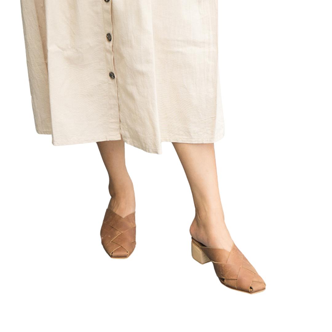 Heeled mules with wide woven leather upper by Seminyak Leather Bali, providing a custom fit. 5 cm wooden block heel in a natural finish. Crazyhorse cow leather sole with nonslip rubber for confident steps. A blend of style and comfort for elevated fashion.