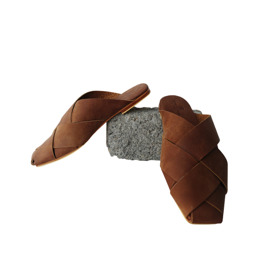 Antique brown leather mules with wide woven leather upper by Seminyak Leather Bali, providing a custom fit. Leather sole with nonslip rubber for confident steps. A blend of style and comfort for elevated fashion.