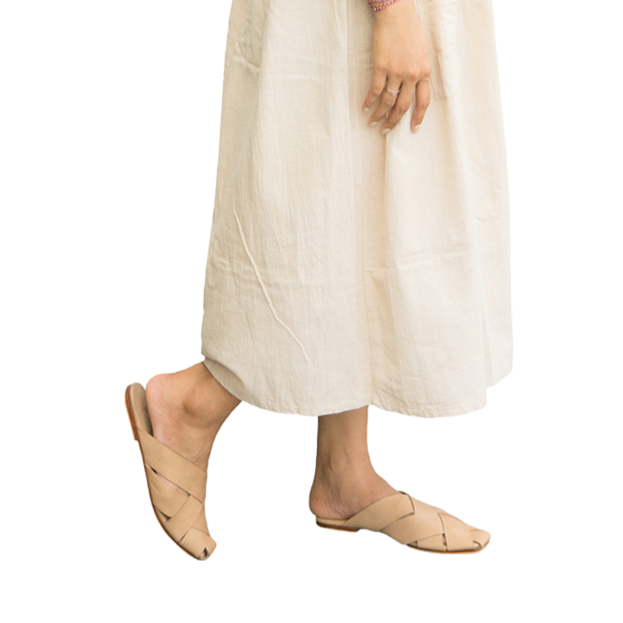 Beige leather mules with wide woven leather upper by Seminyak Leather Bali, providing a custom fit. Leather sole with nonslip rubber for confident steps. A blend of style and comfort for elevated fashion.