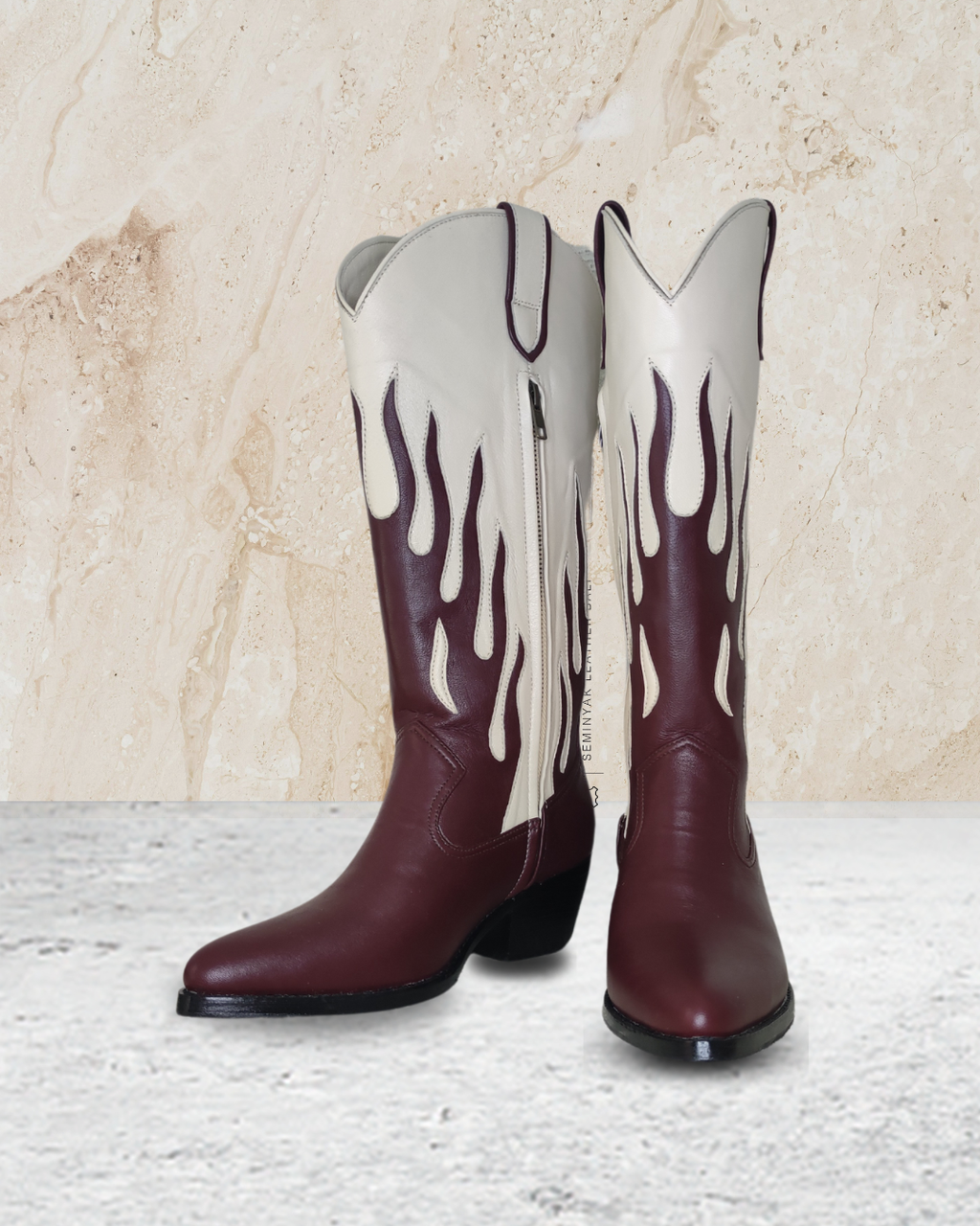 Cowboy boot with ivory top and maroon flames designs by Seminyak Leather Bali on a beige stone background