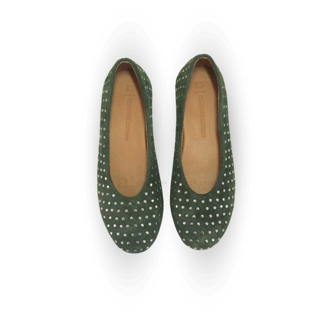 A pair of olive ballet shoes with silver accessories displayed against a white background designs by Seminyak Leather Bali