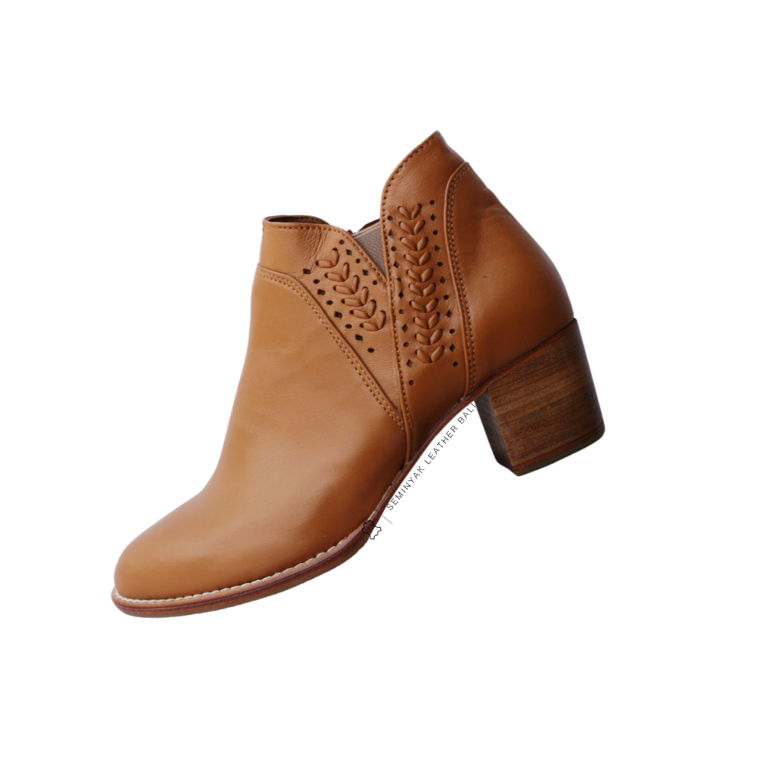 A pair of brown ankle boots with handwoven detailing around the ankle and a block heel designs by Seminyak Leather Bali.