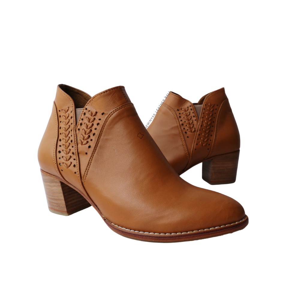 A pair of brown ankle boots with handwoven detailing around the ankle and a block heel designs by Seminyak Leather Bali.