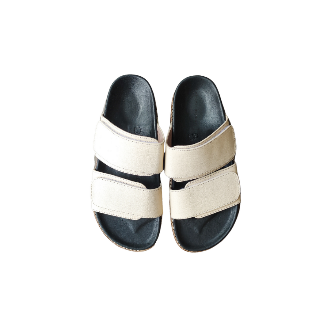 A pair of ivory sandal with double strap velcrow, displayed against a white background designs by Seminyak Leather Bali