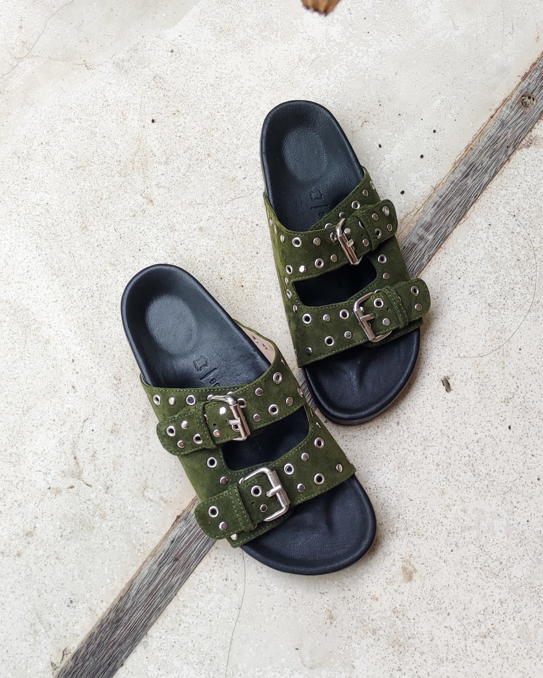 A pair of olive green suede double strap sandals with a anatomic footbed designs by Seminyak Leather Bali
