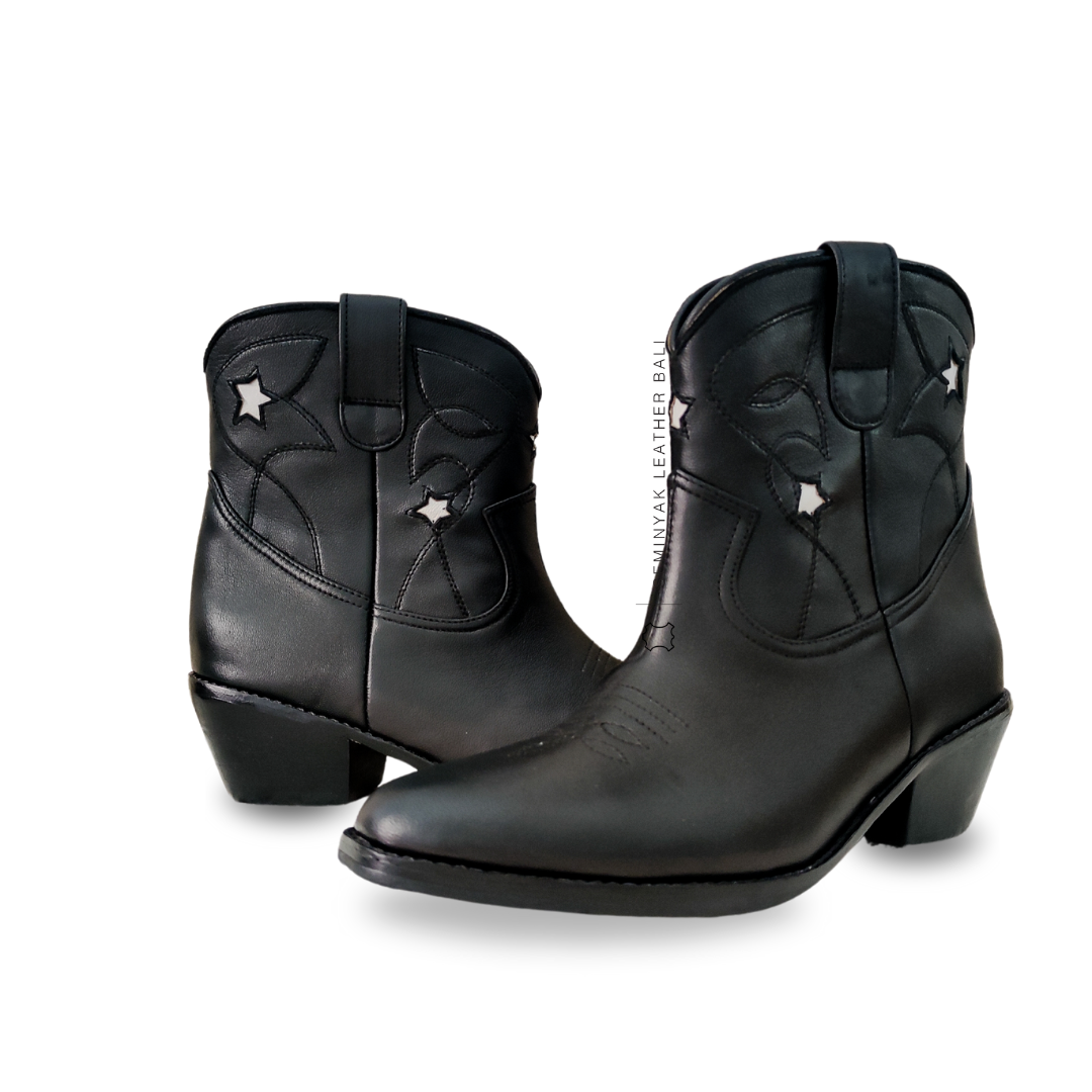 A pair of black and white cowboy boots with a pointy toe and cuban style heels designs by Seminyak Leather Bali.