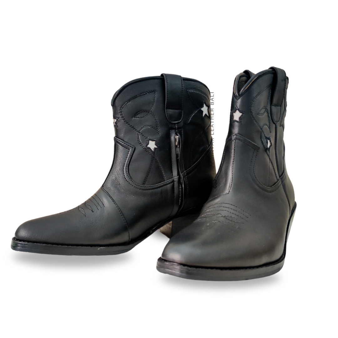 A pair of black and white cowboy boots with a pointy toe and cuban style heels designs by Seminyak Leather Bali.