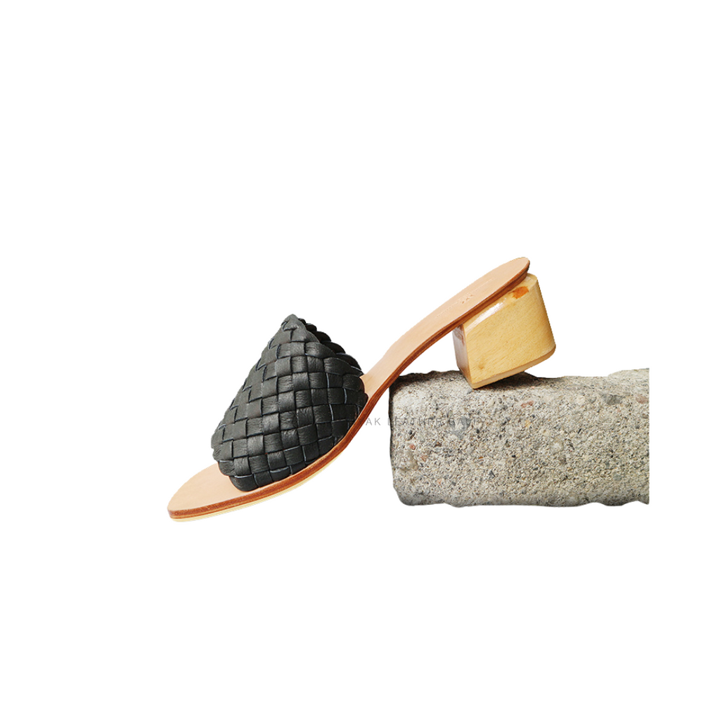 A pair of black woven heels with wooden block heels designs by Seminyak Leather Bali.