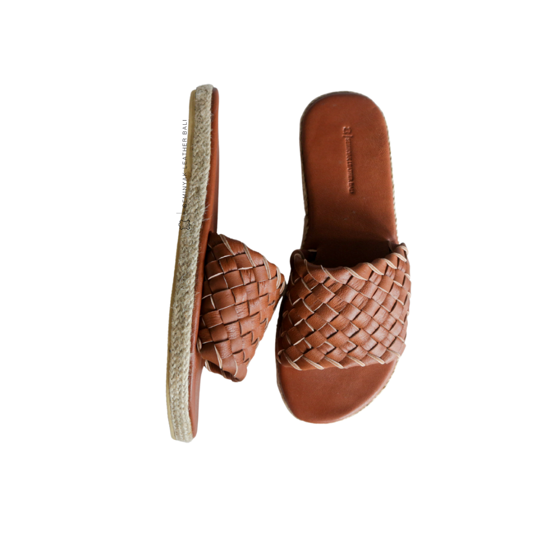 A pair of summer tan wide woven strap sandals with a cushioned sole displayed against a white background designs by Seminyak Leather Bali