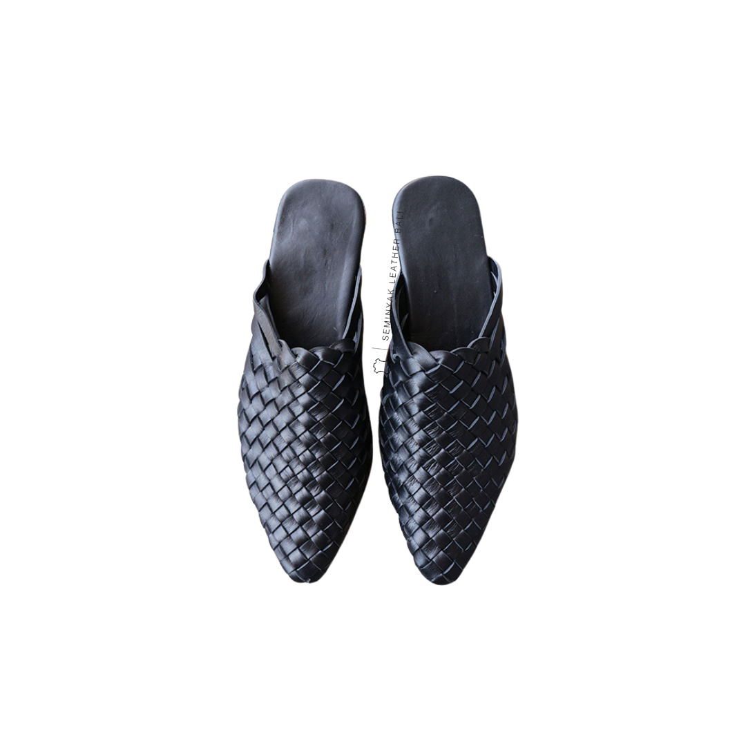 A pair of black pointy woven mules  displayed against a white background designs by Seminyak Leather Bali