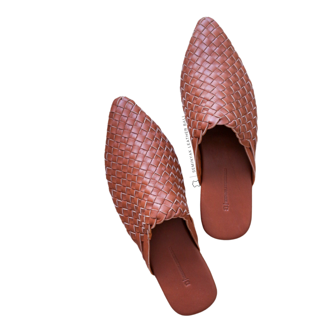 A pair of summer tan pointy woven mules  displayed against a white background designs by Seminyak Leather Bali