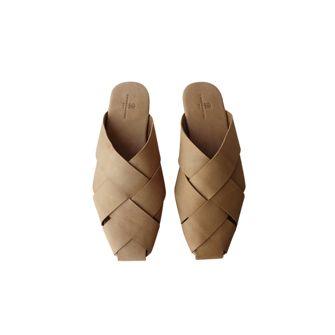 A pair of beige square toe mules  displayed against a white background designs by Seminyak Leather Bali