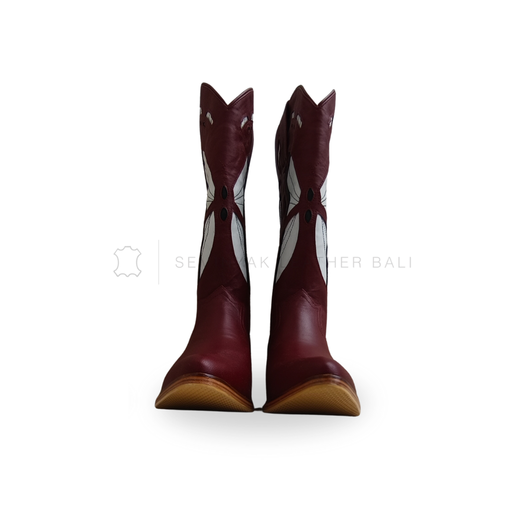Pair of maroon cowboy boots with white star patterns on a white background