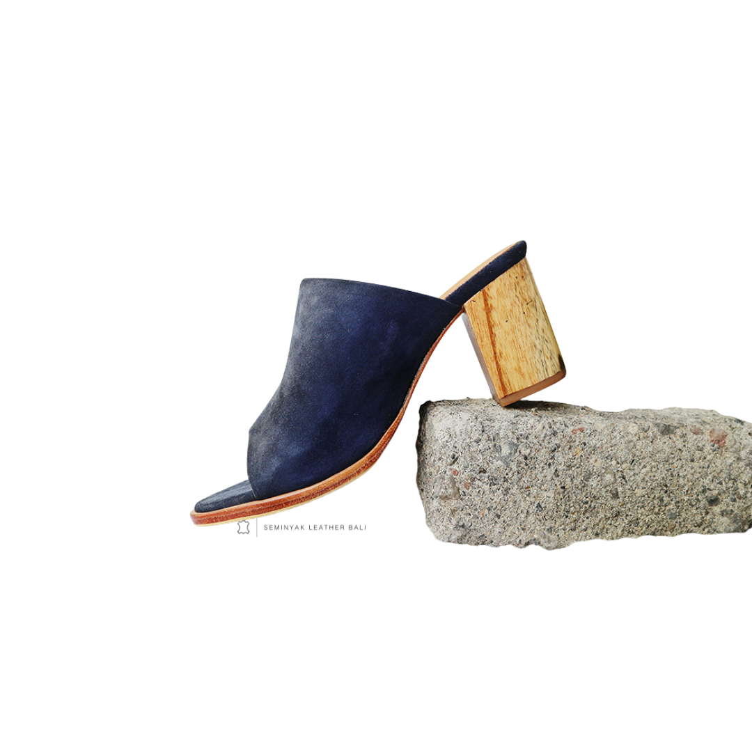 A pair of navy suede mule heels with wooden leather heels and wide straps designs by Seminyak Leather Bali