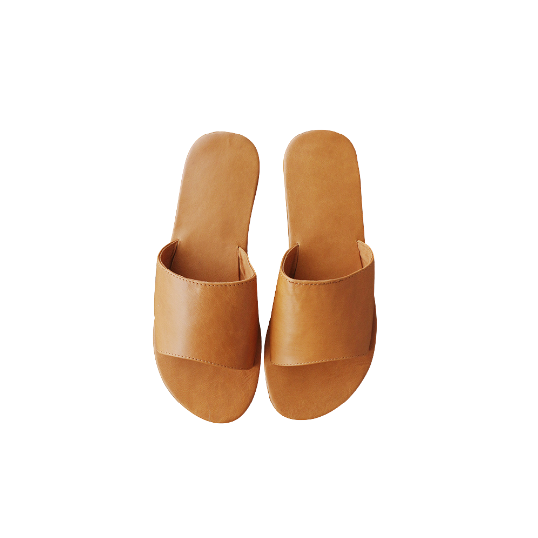 A pair of honey tan genuine goat leather slides with a wide strap designs by Seminyak Leather Bali