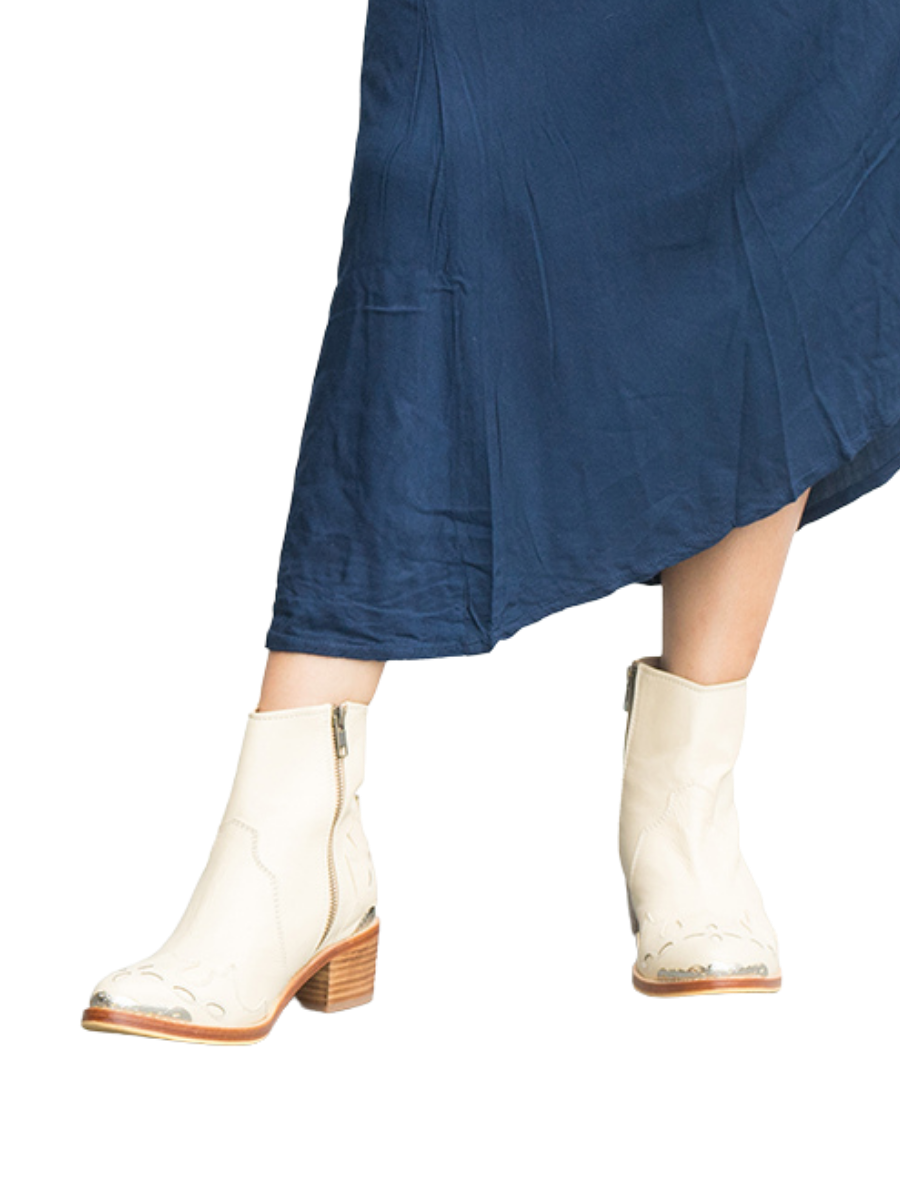 Cream-colored boots, with carved details on the front and back plus metal carving accessories, plus 5 cm high heels that look very elegant and charming. These boots are Canggu Boots, originating from Seminyak Leather Bali.
