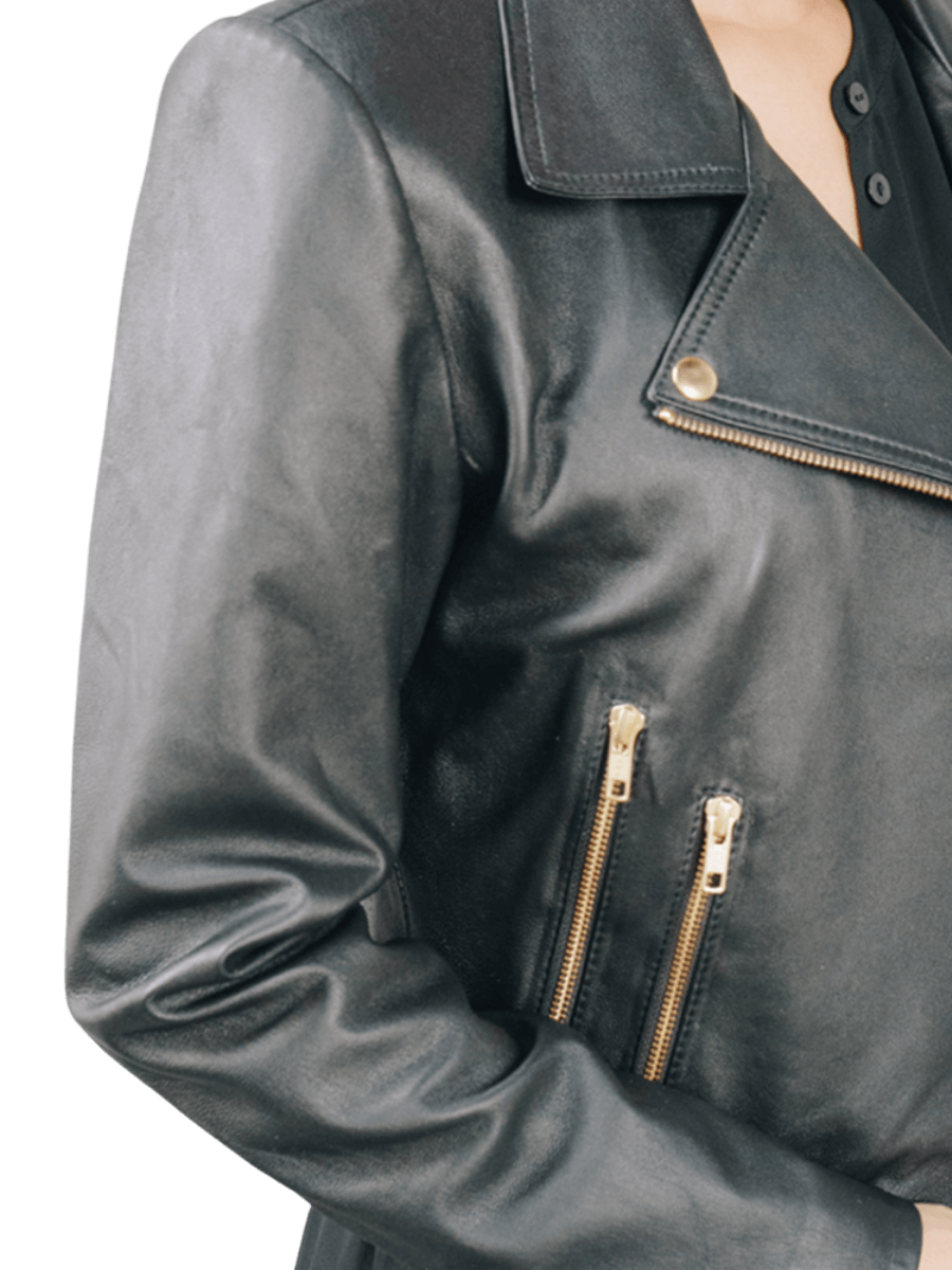 A model wearing a leather Jacket from Seminyak Leather Bali. A black leather jacket with a gold accessory shows the detail of the zip pocket of the Jacket. We proudly present Eliz biker leather jacket for you.