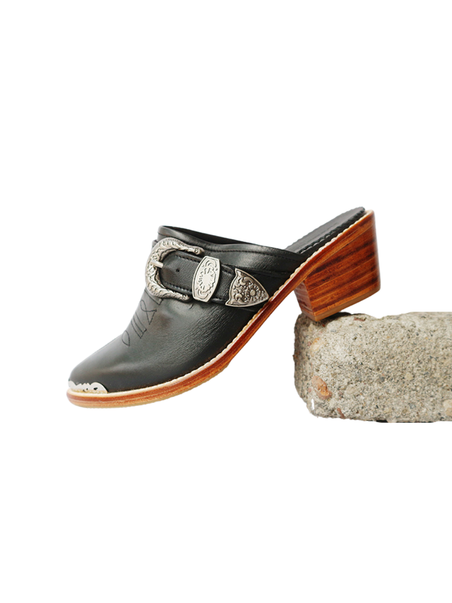 Black pointy toe mules by Seminyak Leather Bali with western-style stitching on vamp and carved metal toe cap. 5 cm wooden Cuban heel in a natural finish. A blend of Western charm and contemporary elegance, all made of leather.