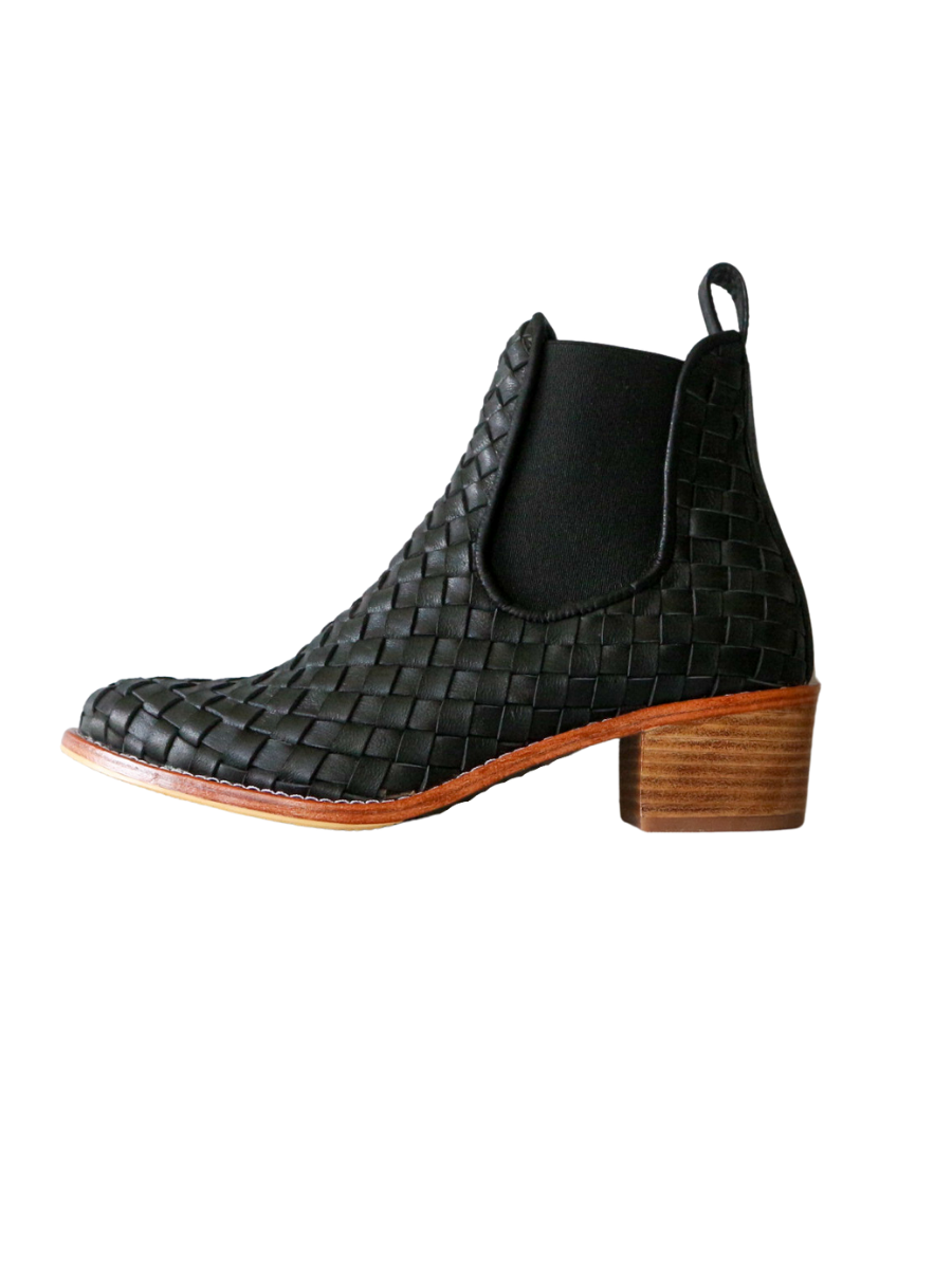 Ankle boots with leather woven detailing in a slim fit cut by Semminyak Leather Bali. Elastic closure with carved metal accents on toe cap and heel. 5 cm wooden heel with a rounded toe design. Stylish and sophisticated footwear with a natural finish, perfect for making a fashion statement.
