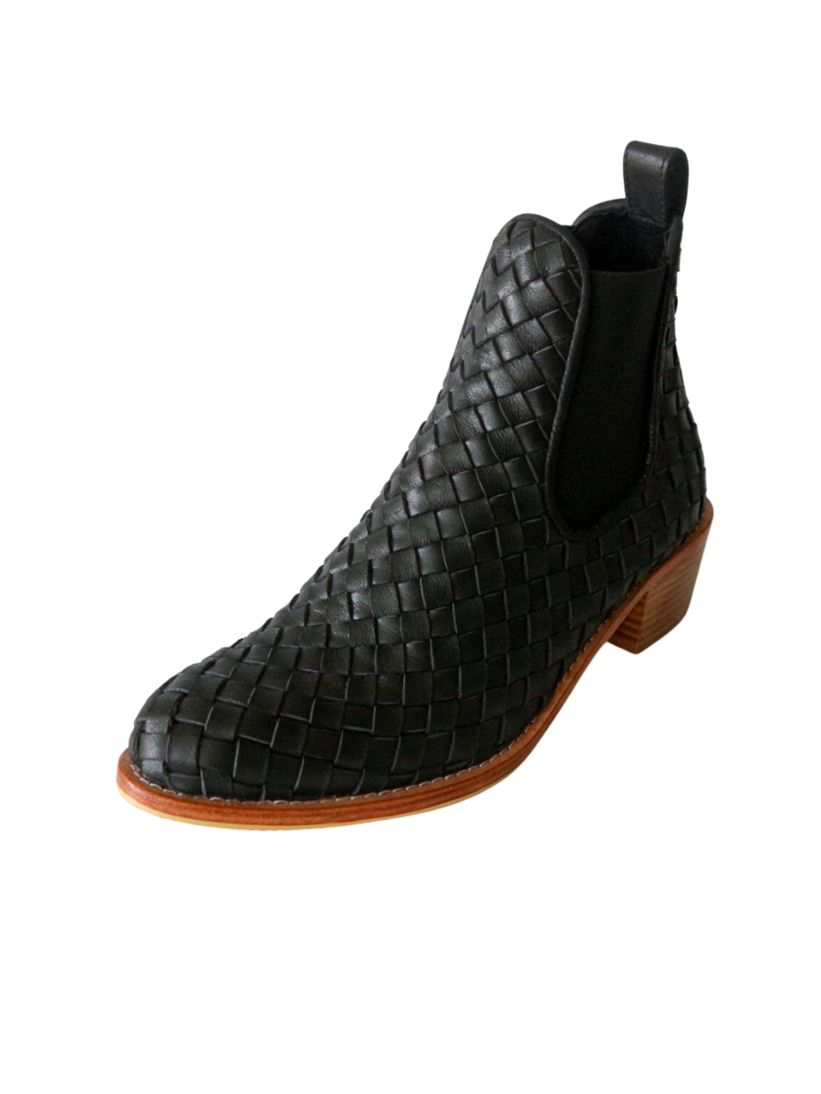 Ankle boots with leather woven detailing in a slim fit cut by Semminyak Leather Bali. Elastic closure with carved metal accents on toe cap and heel. 5 cm wooden heel with a rounded toe design. Stylish and sophisticated footwear with a natural finish, perfect for making a fashion statement.
