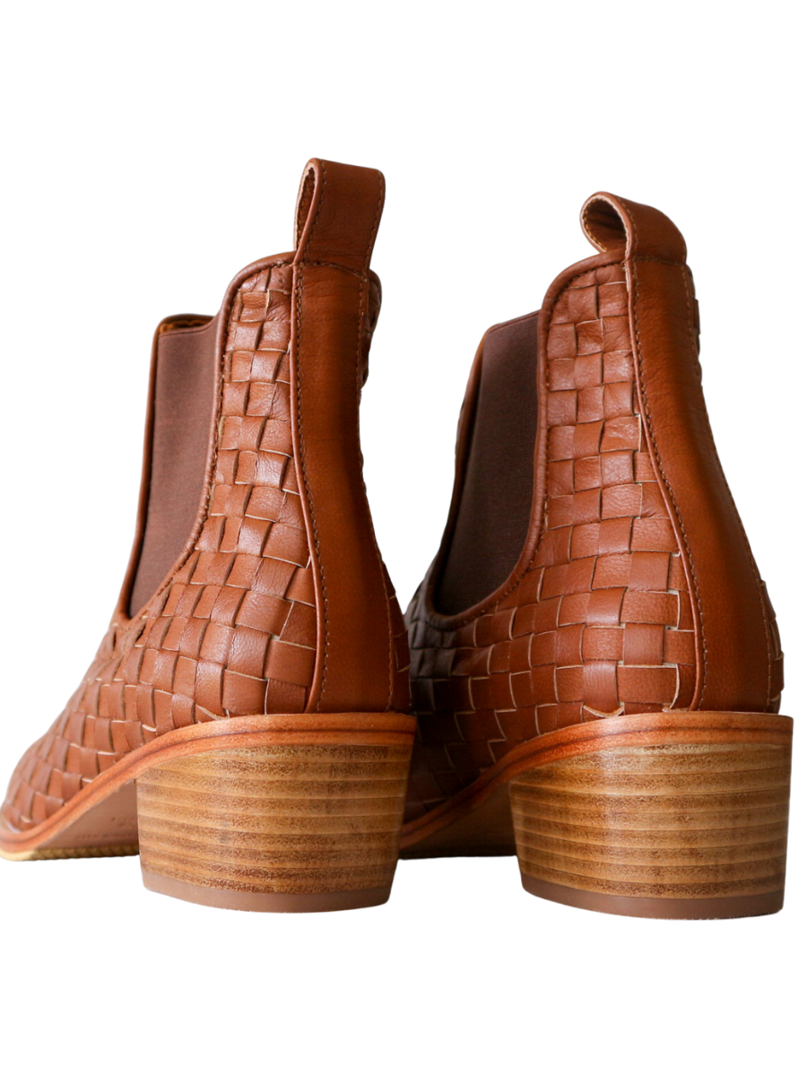 Ankle boots with brown leather woven detailing in a slim fit cut by Semminyak Leather Bali. Elastic closure with carved metal accents on toe cap and heel. 5 cm wooden heel with a rounded toe design. Stylish and sophisticated footwear with a natural finish, perfect for making a fashion statement.