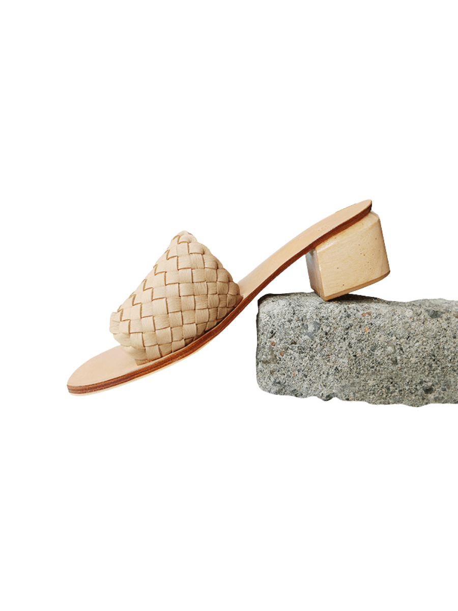 a beige colored summer woven leather heels