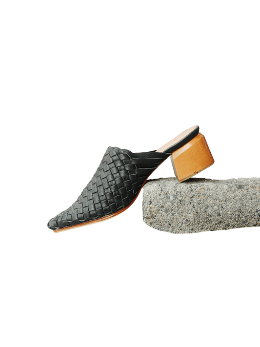 Black pointy woven heels with diagonal cut heels. Woven leather upper for a custom fit. 5 cm height. A blend of modern elegance and artisanal craftsmanship.
