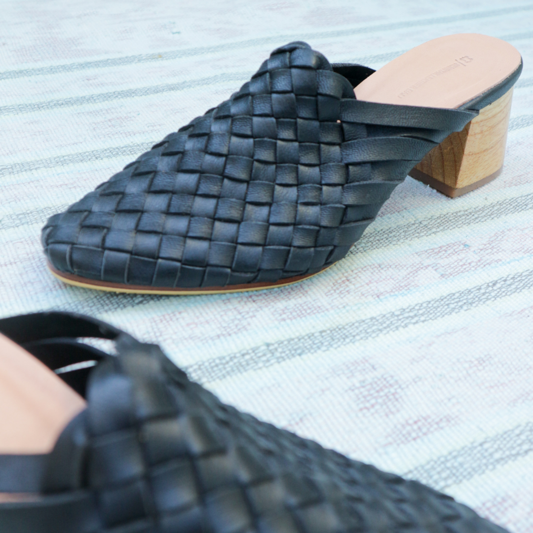 Black heeled mules with woven leather upper for a custom fit by Seminyak Leather Bali. 5 cm wooden block heel in a natural finish. Leather sole with nonslip rubber for confident and comfortable steps.
