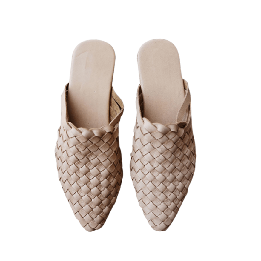 beige leather woven mules upper by Seminyak Leather Bali, providing a custom fit. Leather sole with nonslip rubber comfortable steps. A blend of style and art for elevated fashion.