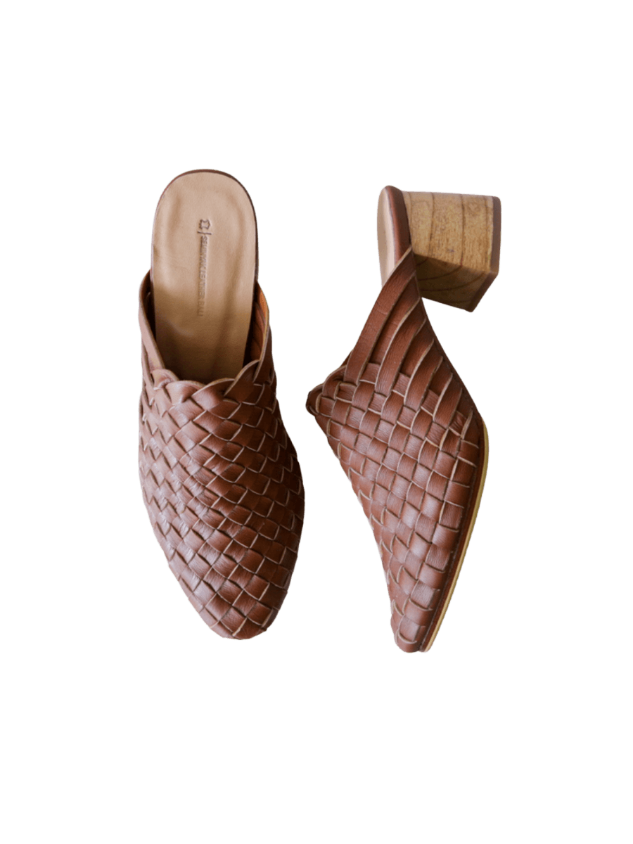 Tan heeled mules with woven leather upper for a custom fit by Seminyak Leather Bali. 5 cm wooden block heel in a natural finish. Leather sole with nonslip rubber for confident and comfortable steps.