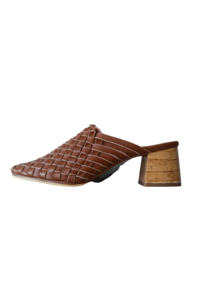 Tan heeled mules with woven leather upper for a custom fit by Seminyak Leather Bali. 5 cm wooden block heel in a natural finish. Leather sole with nonslip rubber for confident and comfortable steps.