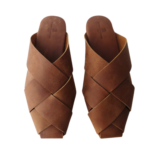 Antique brown leather mules with wide woven leather upper by Seminyak Leather Bali, providing a custom fit. Leather sole with nonslip rubber for confident steps. A blend of style and comfort for elevated fashion.