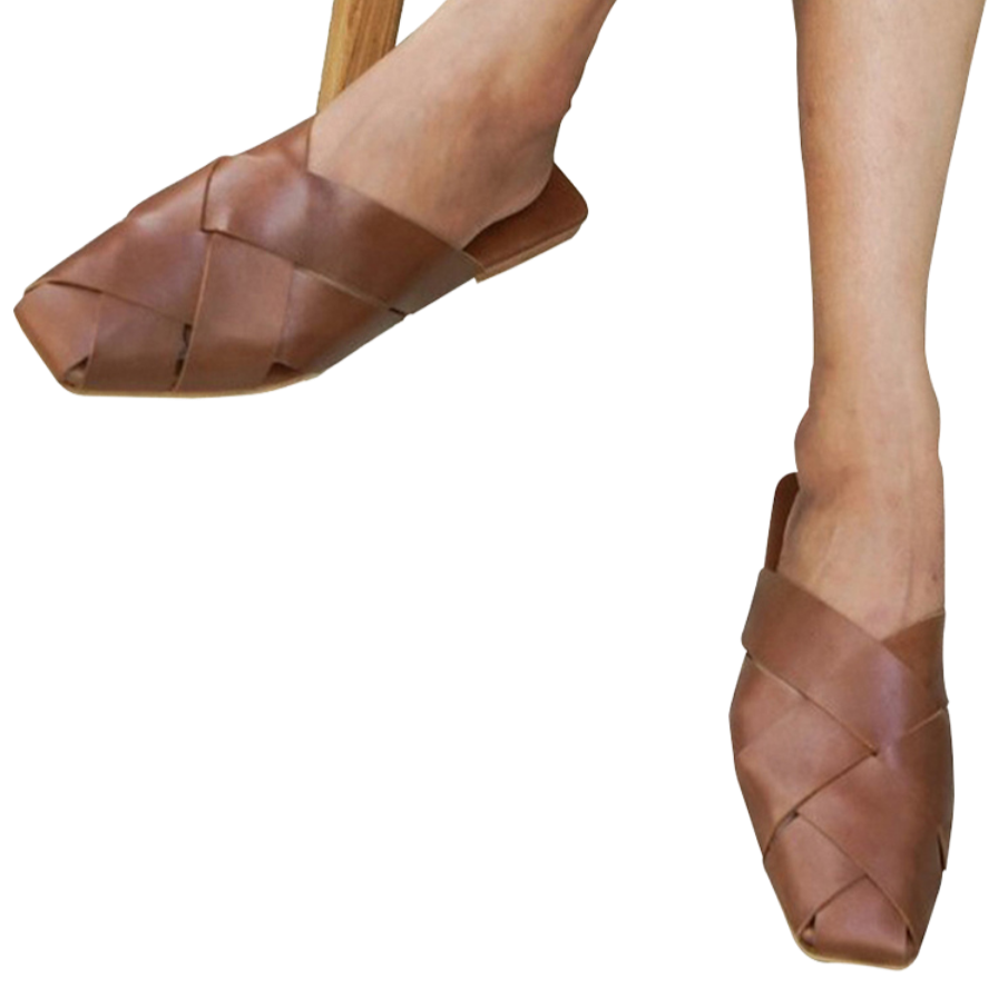 Tan leather mules with wide woven leather upper by Seminyak Leather Bali, providing a custom fit. Leather sole with nonslip rubber for confident steps. A blend of style and comfort for elevated fashion.